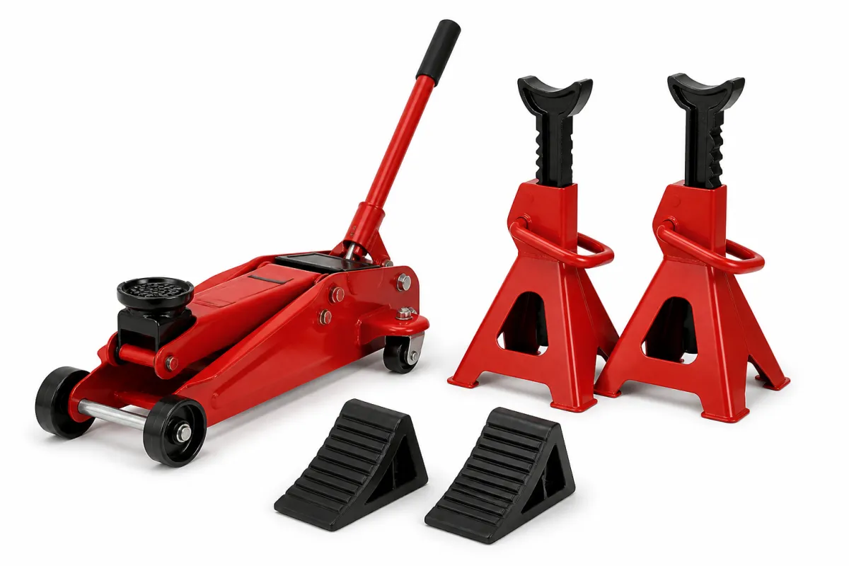 A red hydraulic trolley jack, a pair of red ratchet-type axle stands and two black rubber wheel chocks on a white background