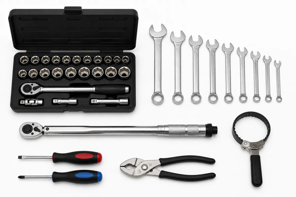 A basic home mechanic tool kit laid out on white: a metric socket set in its case, combination spanners, a torque wrench, an oil filter wrench, pliers and two screwdrivers